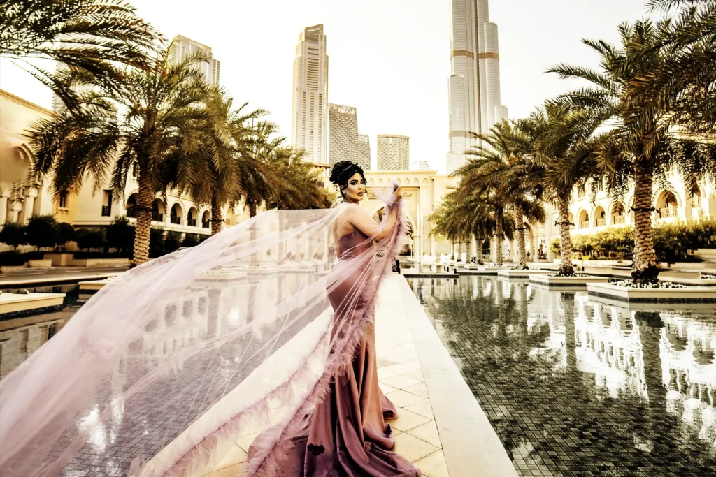 Fashion photography of a model in a pink gown near Burj Khalifa, Dubai